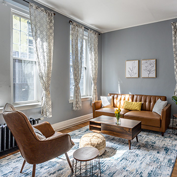 A living room with brown couches