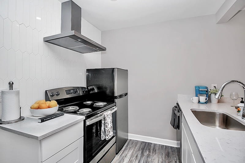 A dark couch in a light living room